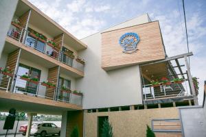 a building with balconies and a sign on it at Villa RK DeLuxe in Zatoka