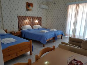 Postel nebo postele na pokoji v ubytování Hotel Apollon