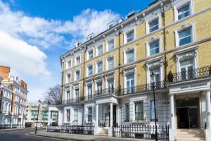 a large brick building with white windows and balconies at The Knaresborough by Nestor in London