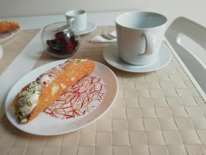 a plate of food on a table with a cup of coffee at Il gelsomino in Scicli