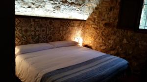 a bedroom with a large bed with a window at El Mangranar in Adzaneta