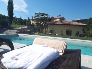 a bed sitting on a table next to a swimming pool at Guest House Stancija Kovacici in Opatija