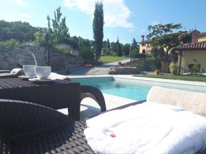 a patio with a table and chairs next to a pool at Guest House Stancija Kovacici in Opatija