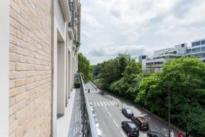 a view of a street from a building with cars parked at Veeve - Contemporary in Balard in Paris