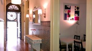 a hallway with a table and a dining room at Hotel Jardim in Coimbra
