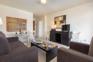 a living room with a couch and a coffee table at Apartamentos Nucleo Cristal in Torremolinos +8 photos