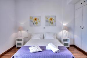 A bed or beds in a room at Athens Glyfada Riviera Apartment