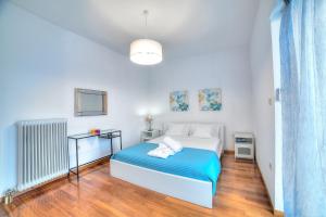 A bed or beds in a room at Athens Glyfada Riviera Apartment