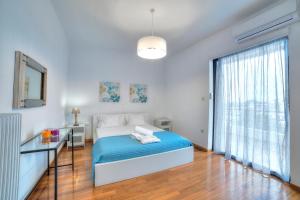 A bed or beds in a room at Athens Glyfada Riviera Apartment