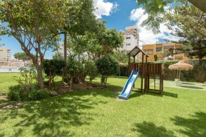 a playground with a slide in a park at Apartamentos Nucleo Cristal in Torremolinos