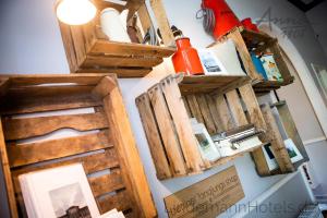 a bunch of wooden frames hanging on a wall at Anna 1908 in Berlin +58 photos