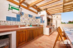 a large kitchen with wooden cabinets and a fireplace at Appartamento le Campanelle in San Felice del Benaco