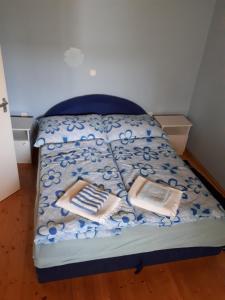 A bed or beds in a room at Németh Apartmanház