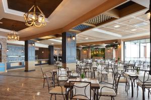 a dining room with tables and chairs at Paradise Beach Residence - Ultra All Inclusive in Sveti Vlas