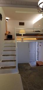 a stairway leading to a room with a bunk bed at Vrahos Boutique Hotel in Karavostasi