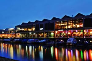 a building with boats in a marina at night at Beautiful large victorian waterfront house in Bristol