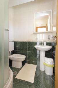 a bathroom with a toilet and a sink at Apartments Nine Slano in Slano +53 photos