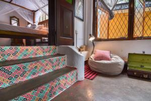 a room with stairs and a chair and a window at Ceylon Boutique Homestay Kandy in Kandy