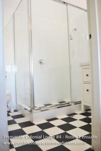 a bathroom with a shower stall and a toilet at Fremantle Colonial Home in Fremantle