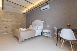 Postel nebo postele na pokoji v ubytování Al Faro Bianco B&B e Residence con parcheggio