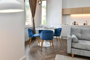 ボーソレイユにあるLuxury Apartment next to Monte Carloのリビングルーム(テーブル、椅子、ソファ付)