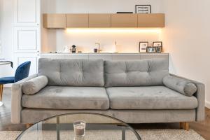 a living room with a couch and a glass table at Luxury Apartment next to Monte Carlo in Beausoleil