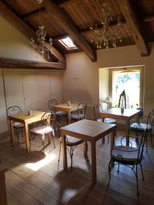 a dining room with tables and chairs and a chandelier at La Carosera in Castellengo