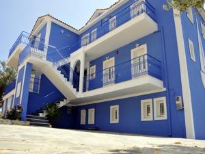 a blue building with white trim and balconies at Folies in Lourdata