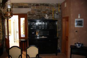 a dining room with a black cabinet and chairs at Apartments Old Isola in the center in Izola