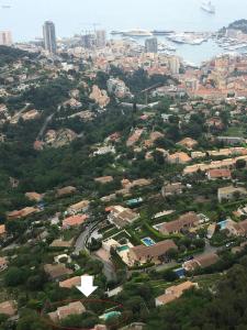 an aerial view of a city with buildings and trees at Monte Carlo View and Spa in La Turbie