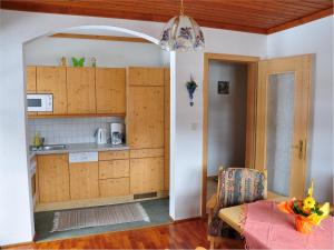 a kitchen with wooden cabinets and a table in a room at Hiaslahof in Mariapfarr