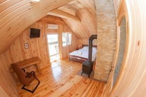 1 dormitorio con estufa de leña en una cabaña de madera en Ostrivky, en Svityazʼ 90 fotos más