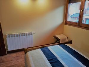 A bed or beds in a room at Apartamento Mirador Del Puigmal