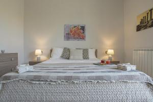 a bedroom with a large bed with two lamps at Casa vacanze Cannatello Home in Villaggio Mosè