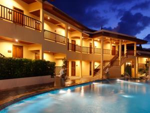 a house with a swimming pool in front of it at Baan Yuree Resort & Spa - SHA Plus in Patong Beach