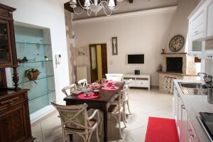 a kitchen and dining room with a table and chairs at Palazzina Porta di Mare in Bisceglie +35 photos