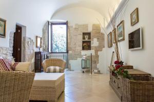 a living room with a couch and chairs and a window at Palazzina Porta di Mare in Bisceglie