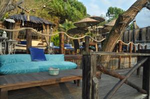 a porch with a blue couch on a deck at Lethe Exclusive Hotel in Ağva