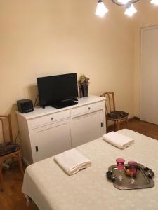 a room with a table with a tv on top at Art island house in Athens