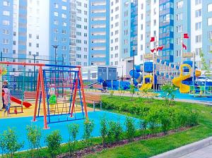 a park with a playground with a slide at Aristokrat Apartments in Yekaterinburg