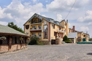 a large building on a street in a town at Aivengo Hotel in Rivne