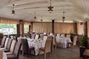 a large dining room with tables and chairs at Aivengo Hotel in Rivne
