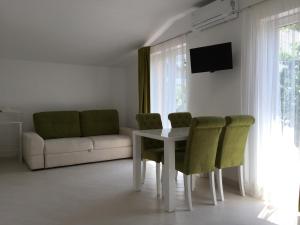a living room with a table and chairs and a couch at Guest House in Mukacheve