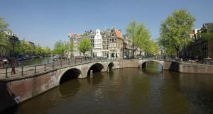 a bridge over a river in a city at Milkhouse Luxury Stay Amsterdam in Amsterdam