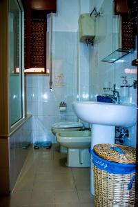 a bathroom with a sink and two toilets in it at Piana delle Galee in Scilla +82 photos