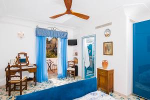 uma sala de estar com um sofá azul e uma mesa em Dimora del Podestà em Positano