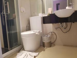a bathroom with a toilet and a sink and a shower at Kavin Buri Green Hotel in Udon Thani