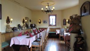 a dining room with tables and a teddy bear on the wall at Hotel Zum Schwarzen Bär in Hermsdorf