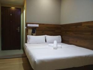 Voodi või voodid majutusasutuse Qing Yun Rest House Gadong, Brunei Darussalam toas