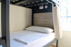 A bed or beds in a room at Alberg Costa Brava